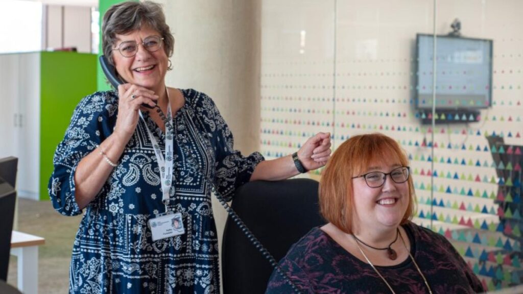 A photo of the Local Offer team; Kathy Forsdyke and Julia Smith. Kathy is on the phone and Julia is working at a desk.